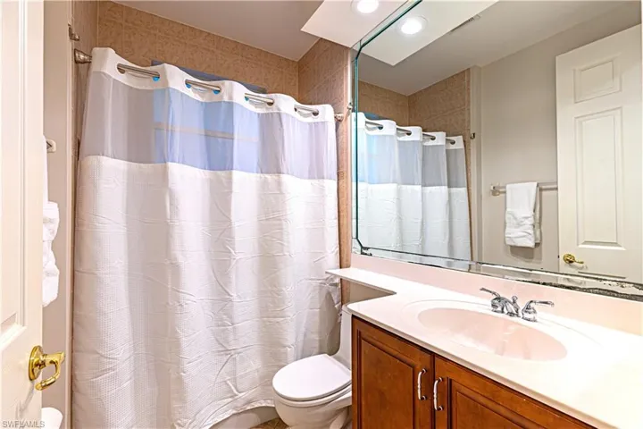 Bathroom with walk in shower, vanity, and toilet