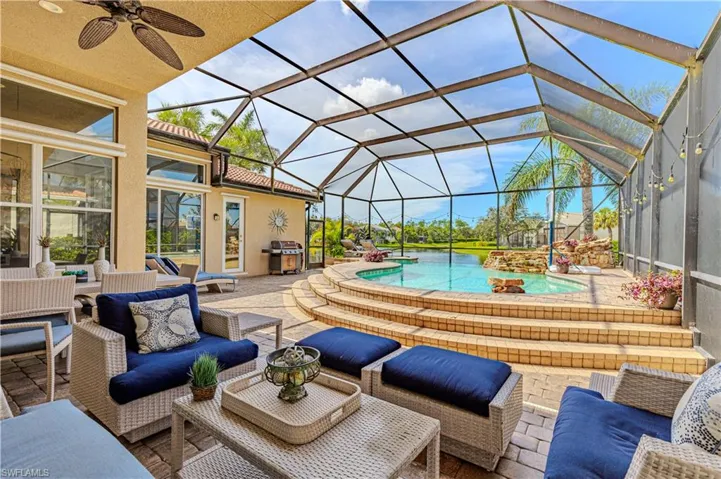 View of patio featuring ceiling fan, area for grilling, outdoor lounge area, a lanai, and a hot tub