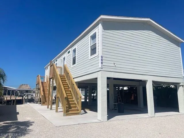 View of side of home with a patio area and a carport