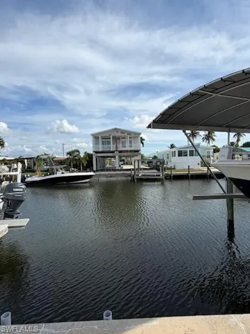 Dock area with a water view and boat lift