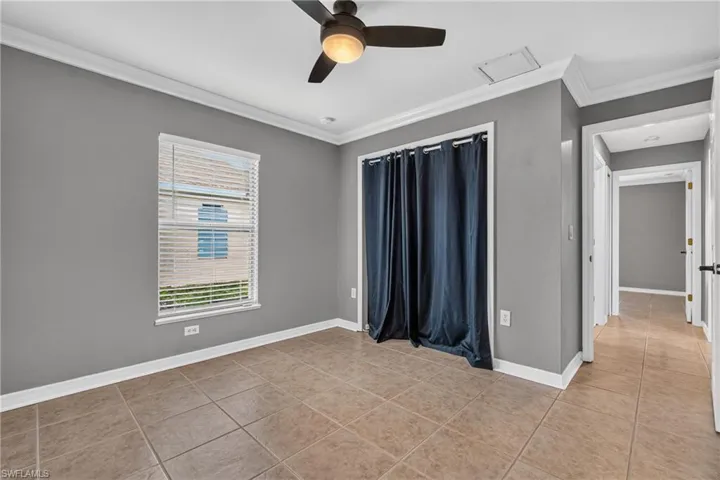 Neutral gray walls complemented by white crown molding and baseboards