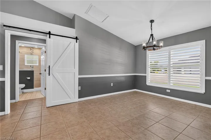 Dining area with Barn door to enter the hall way where spare rooms and main bath are