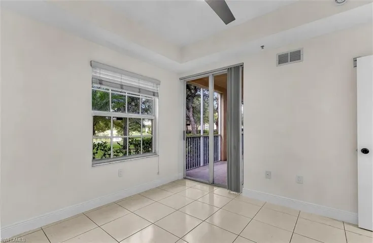 Unfurnished room with light tile patterned floors and ceiling fan