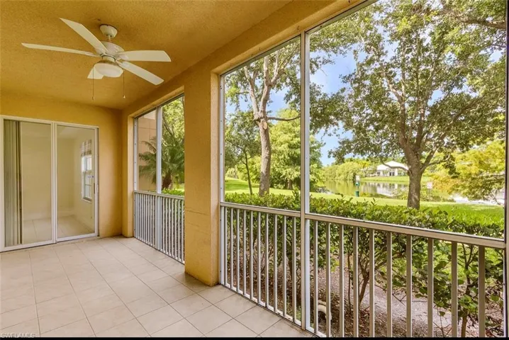 Unfurnished sunroom featuring ceiling fan and a water view