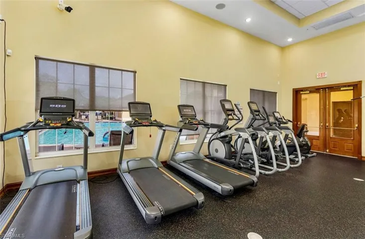 Workout area with a towering ceiling and baseboards