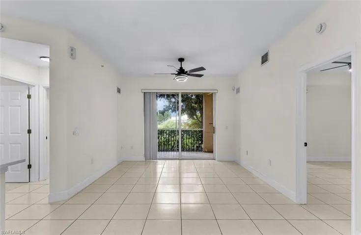 Spare room with light tile patterned flooring and a ceiling fan