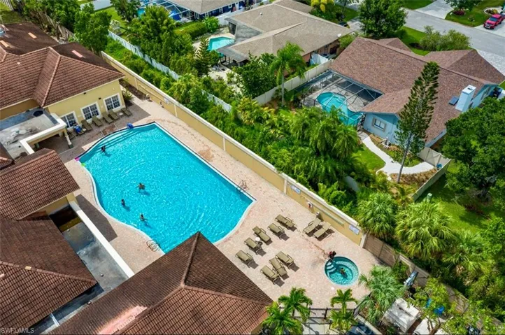 Community pool with a patio and a residential view