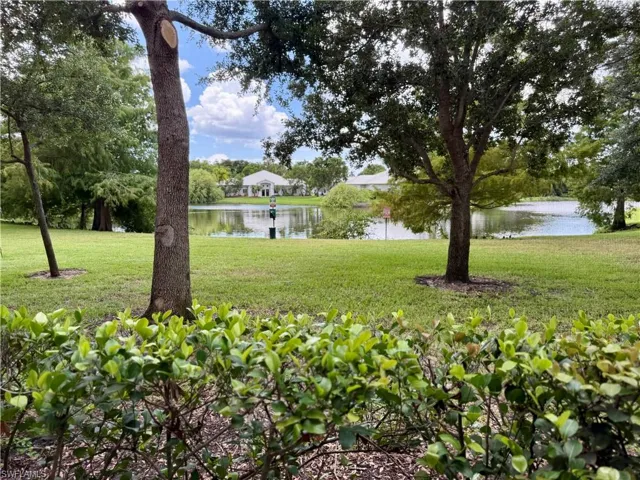 View of green lawn featuring a water view