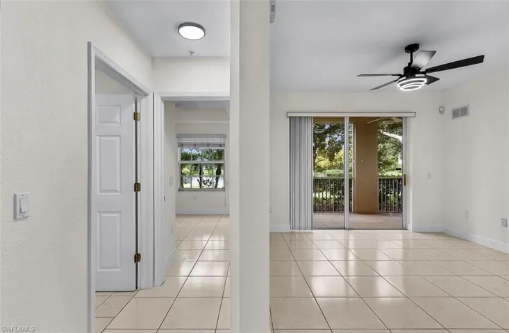 Spare room with light tile patterned floors and ceiling fan
