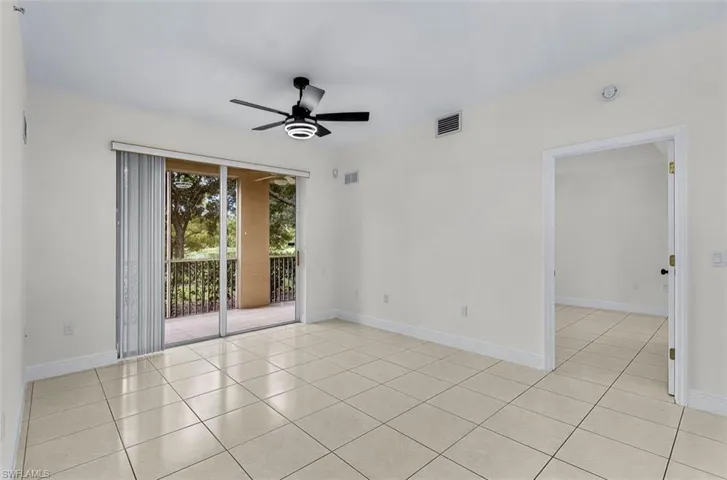 Unfurnished room featuring light tile patterned floors and a ceiling fan