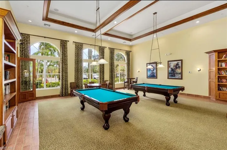 Recreation room featuring billiards, a towering ceiling, a raised ceiling, recessed lighting, and beam ceiling
