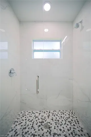 Glass Enclosed Walk-In Shower With Pebble Flooring In Master Bathroom!