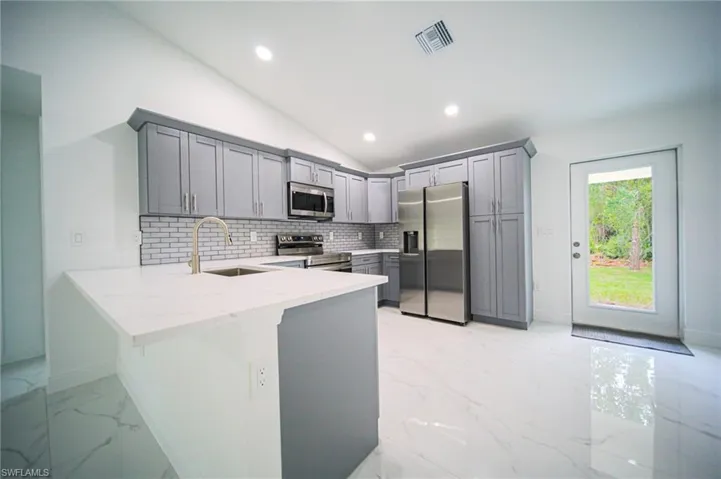The Kitchen Comes With Quartz Countertops, Grey Soft Close Cabinets & Drawers, Grey Subway Tile Backsplash, A Floor To Ceiling Pantry, A Quartz Peninsula That Seat Three People, And Brand New Stainless Steel Appliances!