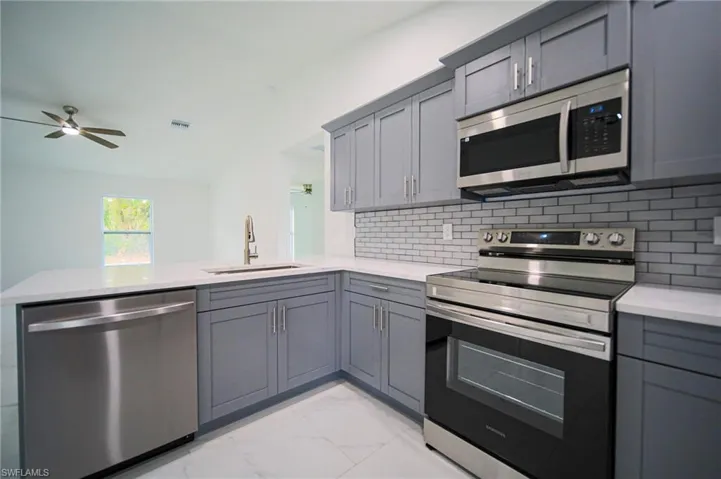 The Kitchen Comes With Quartz Countertops, Grey Soft Close Cabinets & Drawers, Grey Subway Tile Backsplash, A Floor To Ceiling Pantry, A Quartz Peninsula That Seat Three People, And Brand New Stainless Steel Appliances!