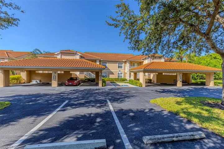 View of property featuring covered parking