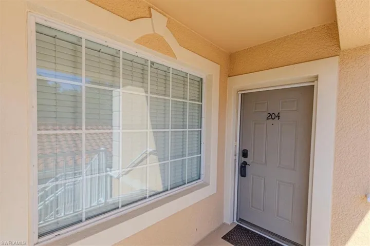 Doorway to property with stucco siding