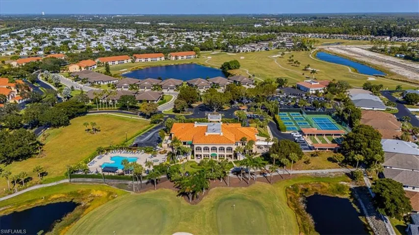 Aerial overview of property's location featuring a nearby body of water, a golf course, and nearby suburban area
