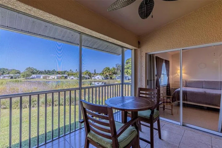 Sunroom featuring a water view