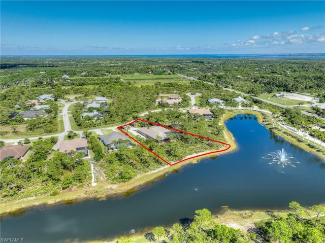 Aerial perspective of home with lake and property boundaries highlighted