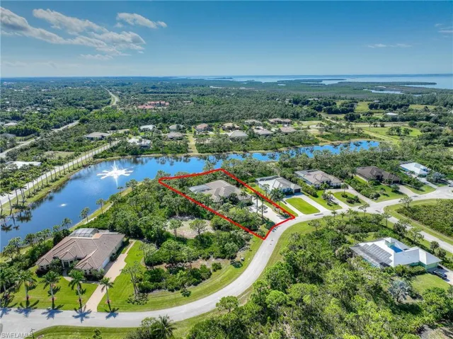 Aerial perspective of home, community, lake and property boundaries highlighted