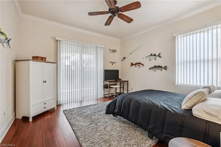 This room features ornamental molding, wood flooring, and ceiling fan and private entrance to lanai. This room can be used as an office or guest suite.