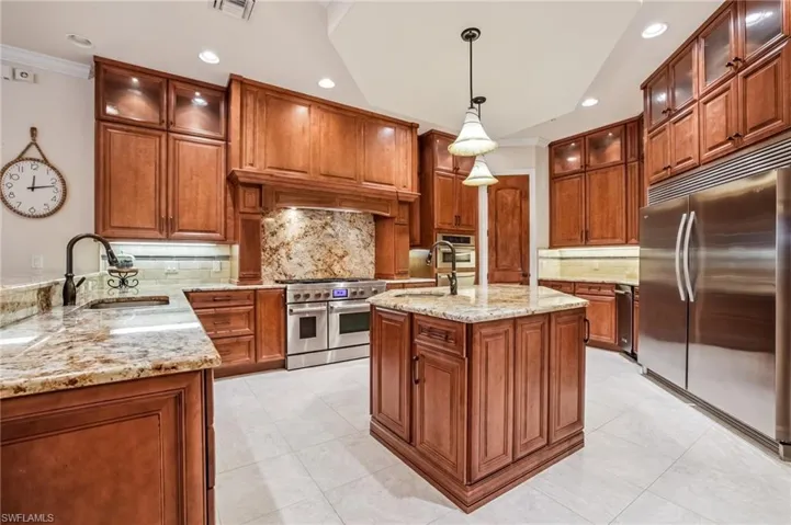 Kitchen wood cabinets, walk-in pantry, crown molding, granite countertops, JennAir 6 gas burner stove with 2 ovens, microwave and warming drawer