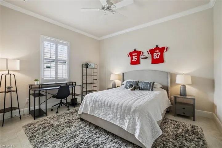 Bedroom featuring ornamental molding, ceiling fan, and closet