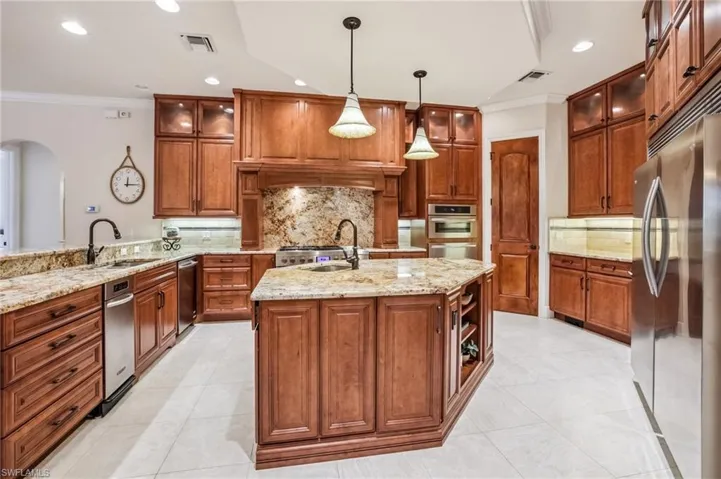 Kitchen wood cabinets, walk-in pantry, crown molding, granite countertops, JennAir 6 gas burner stove with 2 ovens, microwave and warming drawer