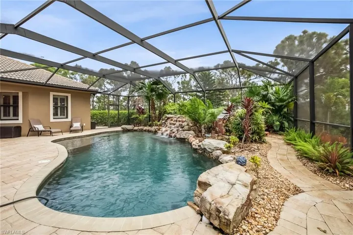 Swimming pool featuring upgraded landscaping and stand alone hot tub.