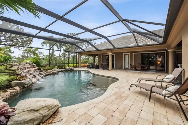 Outdoor pool featuring a patio area, a lanai, outdoor dining space and sitting area, and a ceiling fan