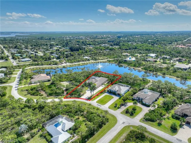 Aerial perspective of home, community and lake and property boundaries highlighted