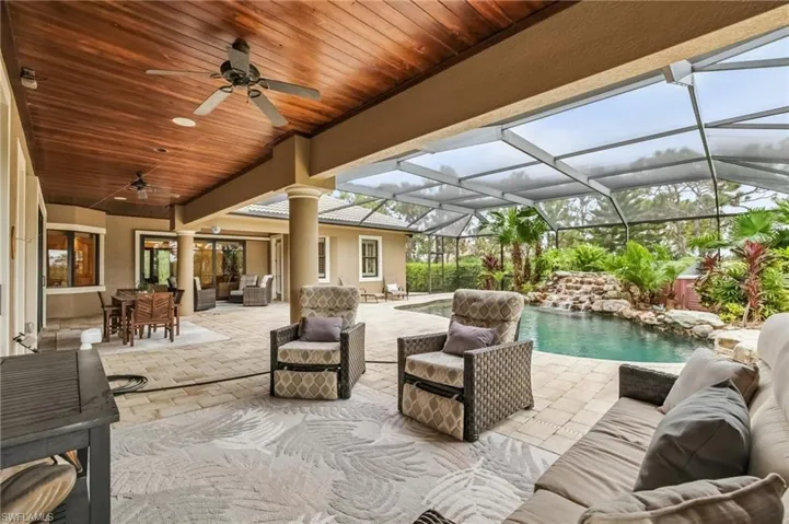 View of patio featuring an outdoor sitting area, ceiling fan, and pool