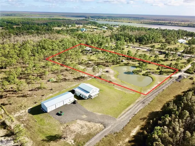 Aerial view of property's location featuring property parcel outlined and a nearby body of water