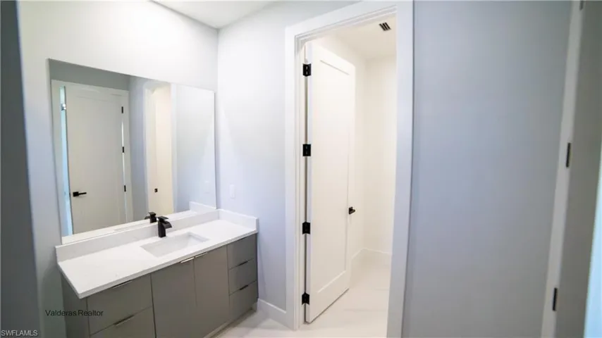 Half bath with vanity and baseboards