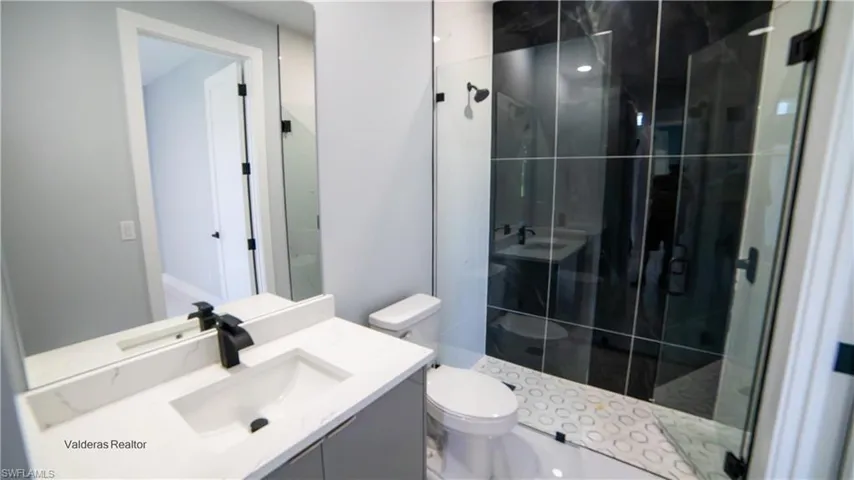 Full bath featuring vanity and a shower stall