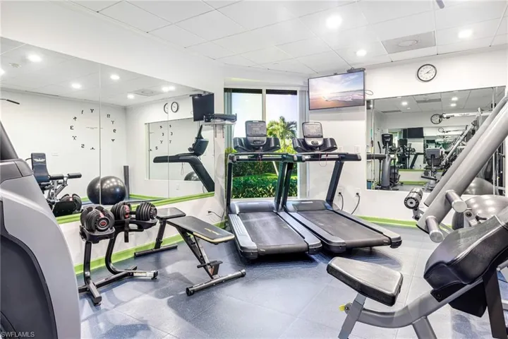 Gym featuring a drop ceiling and crown molding
