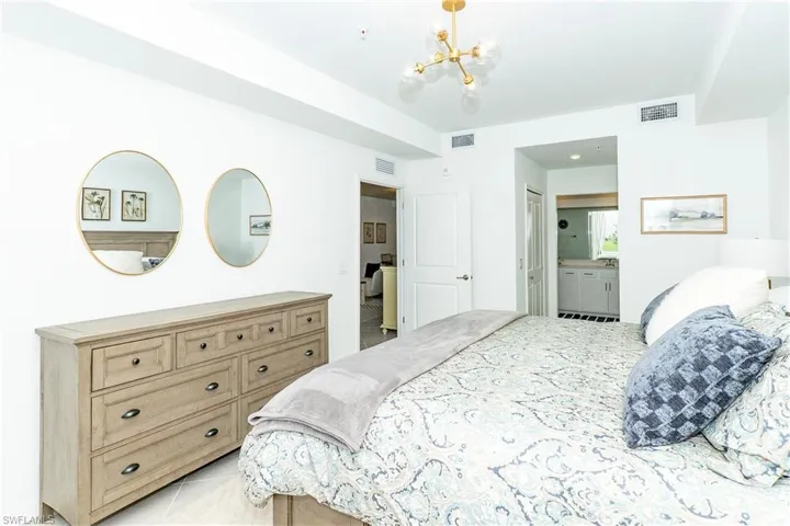Bedroom featuring a chandelier and light tile patterned floors