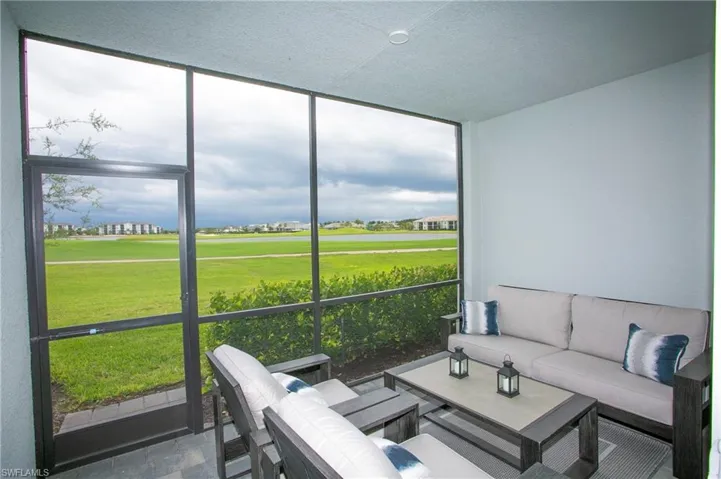 Sunroom featuring view of golf course