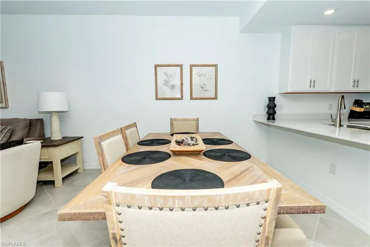 Dining space featuring light tile patterned floors and recessed lighting