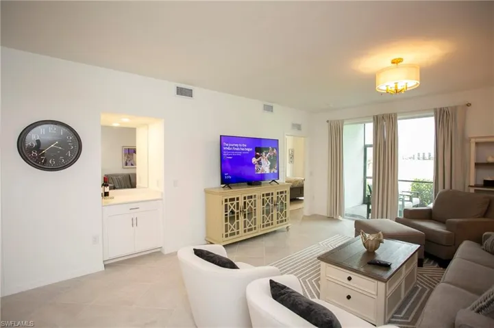 Living room featuring light tile patterned flooring and baseboards