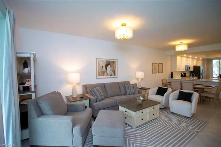 Tiled living area featuring a sink