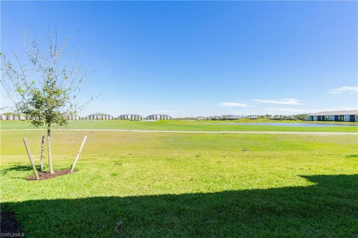 View of grassy yard featuring a water view and view of golf course