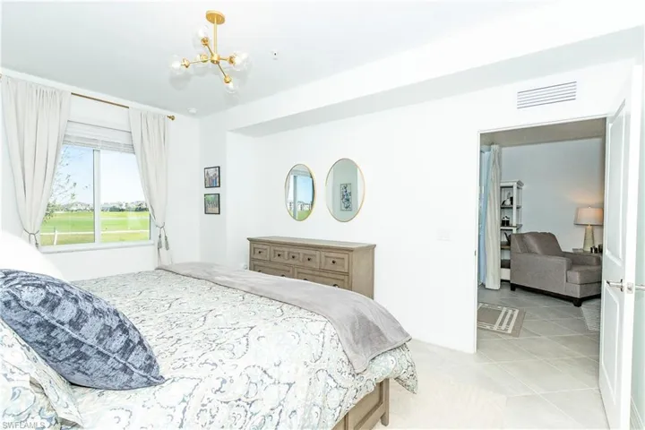 Bedroom featuring a chandelier and light tile patterned floors