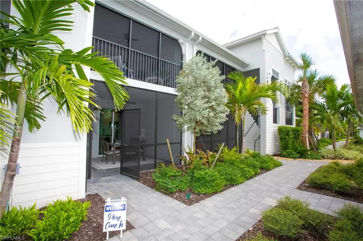 View of home's exterior with a sunroom, a balcony, and stucco siding