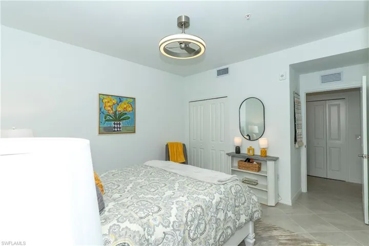 Bedroom with a closet and light tile patterned flooring