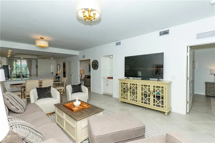 Living room with light tile patterned floors and baseboards