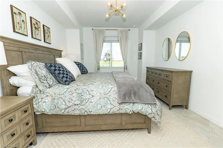 Bedroom featuring a chandelier and light tile patterned floors
