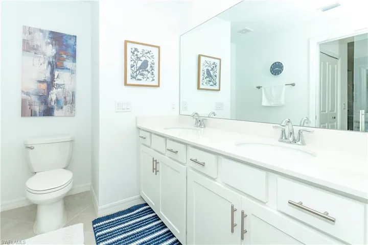 Bathroom featuring double vanity and tile patterned flooring