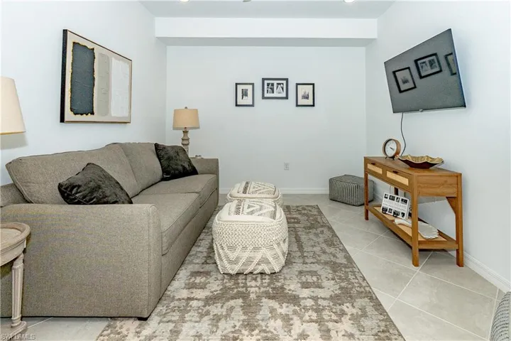 Living area featuring baseboards and light tile patterned flooring