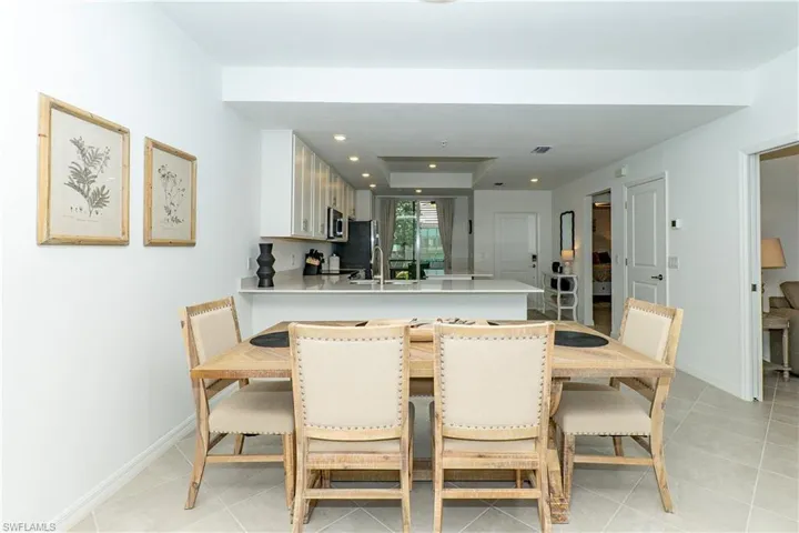 Dining space featuring light tile patterned floors and recessed lighting